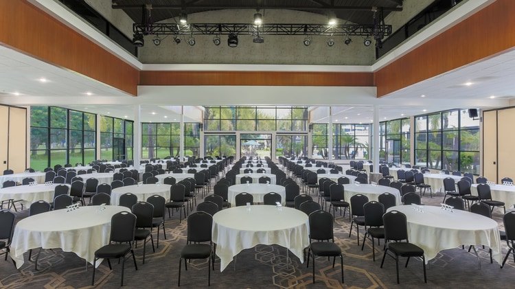 Large event hall set with round tables